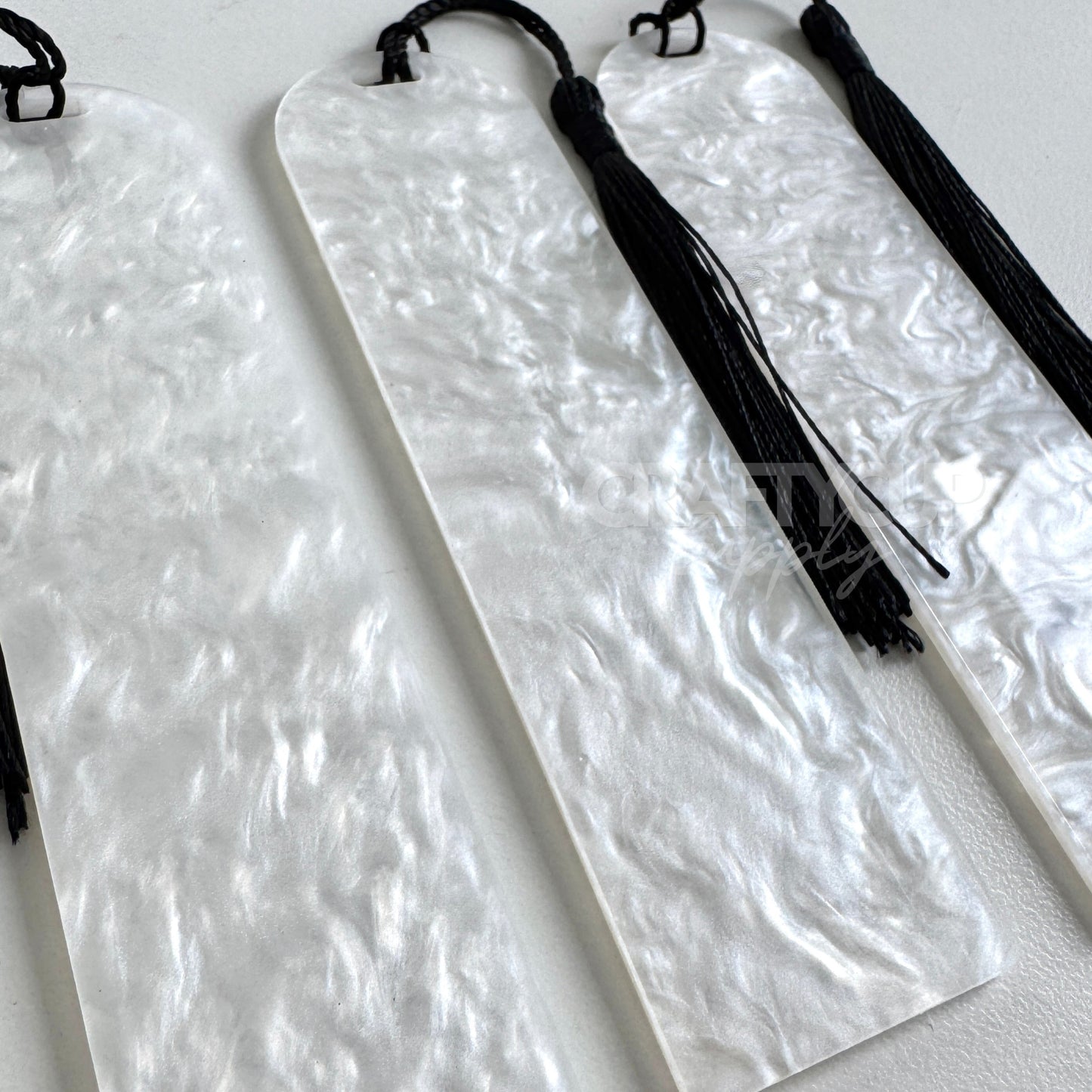 Oil slick swirl acrylic bookmark blank measuring 12x3.2cm with unique embedded pattern, clear finish, pre-cut hole, and included tassel – perfect for UV DTF and vinyl crafting.