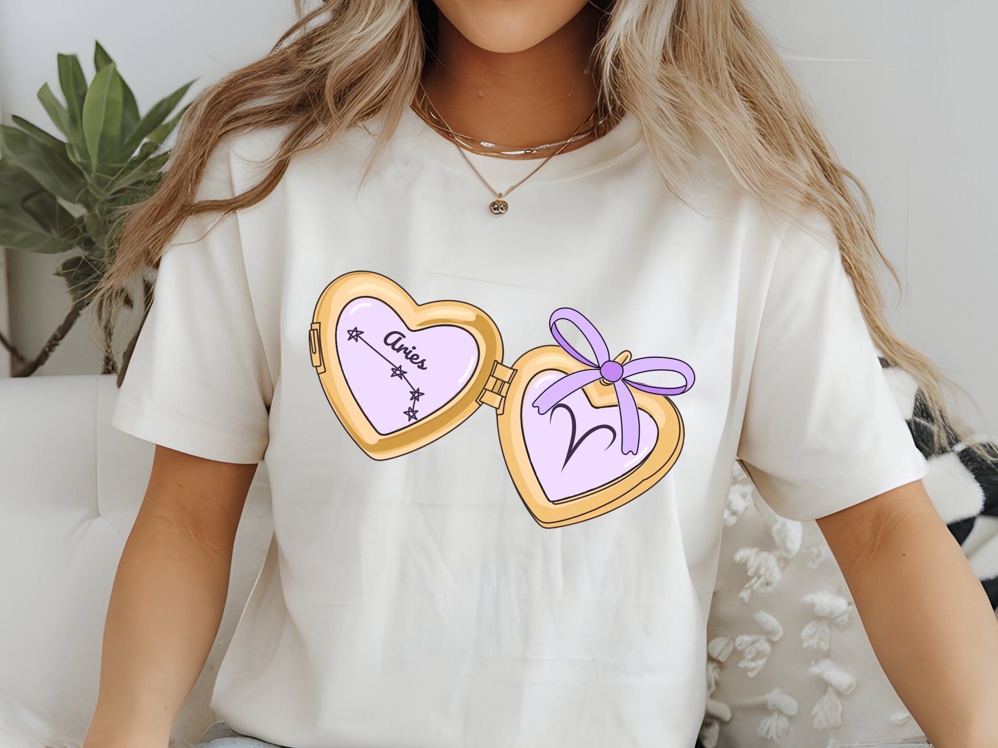 a cute trending and popular PNG digital download design of a gold love heart locket featuring a zodiac star sign and constellation symbol, finished with a purple lilac bow.  Can be used to create physical stickers or use for sublimation on clothing such as t shirts, jumpers and canvas bags