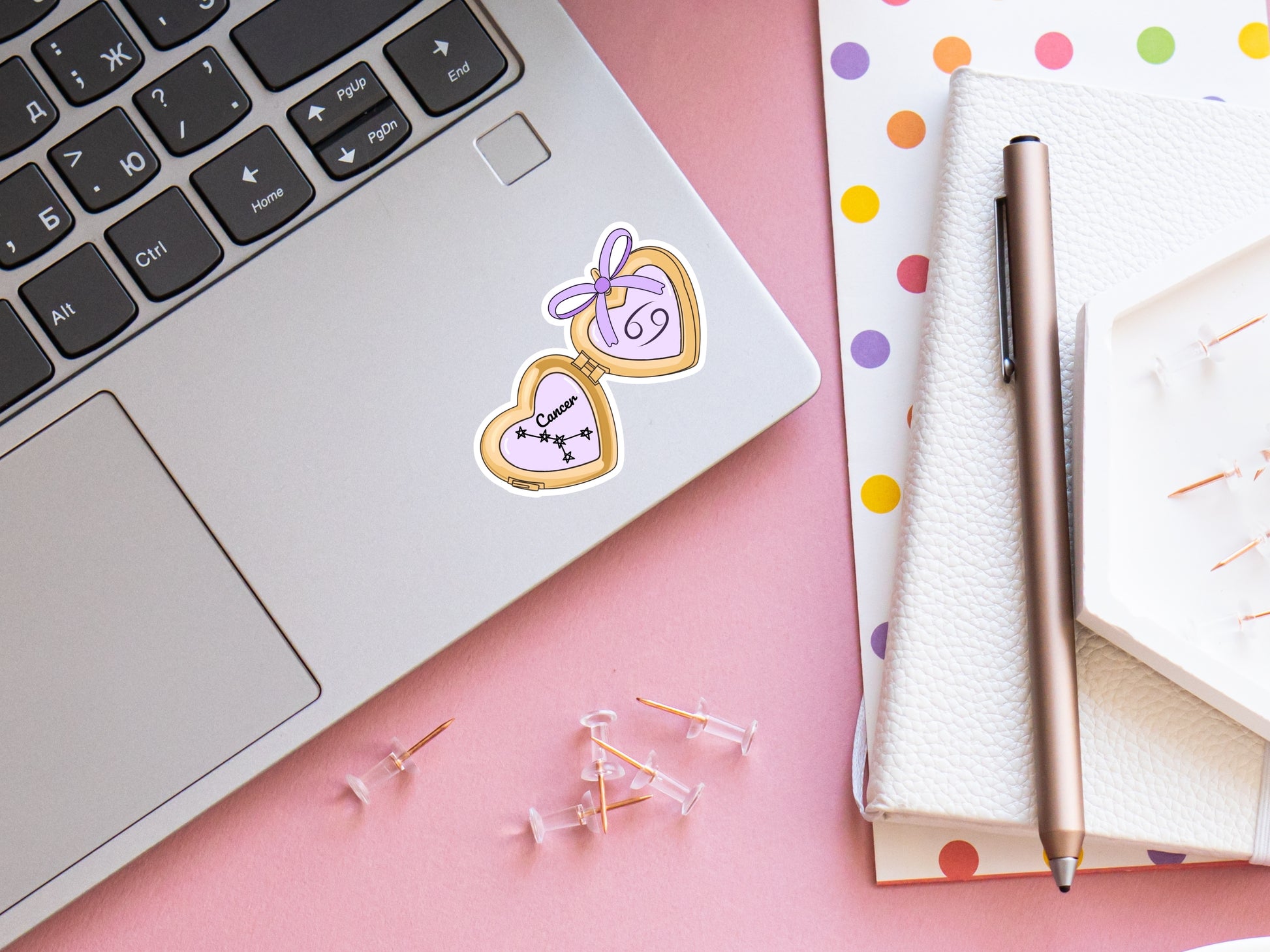 a cute trending and popular PNG digital download design of a gold love heart locket featuring a zodiac star sign and constellation symbol, finished with a purple lilac bow.  Can be used to create physical stickers or use for sublimation on clothing such as t shirts, jumpers and canvas bags