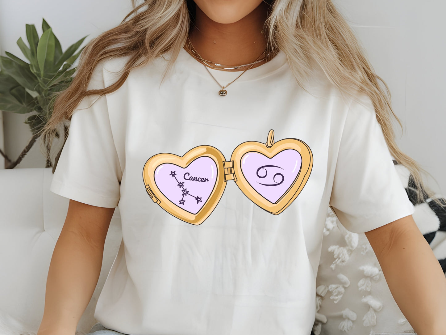 a cute trending and popular PNG digital download design of a gold love heart locket featuring a zodiac star sign and constellation symbol, finished with a purple lilac bow.  Can be used to create physical stickers or use for sublimation on clothing such as t shirts, jumpers and canvas bags