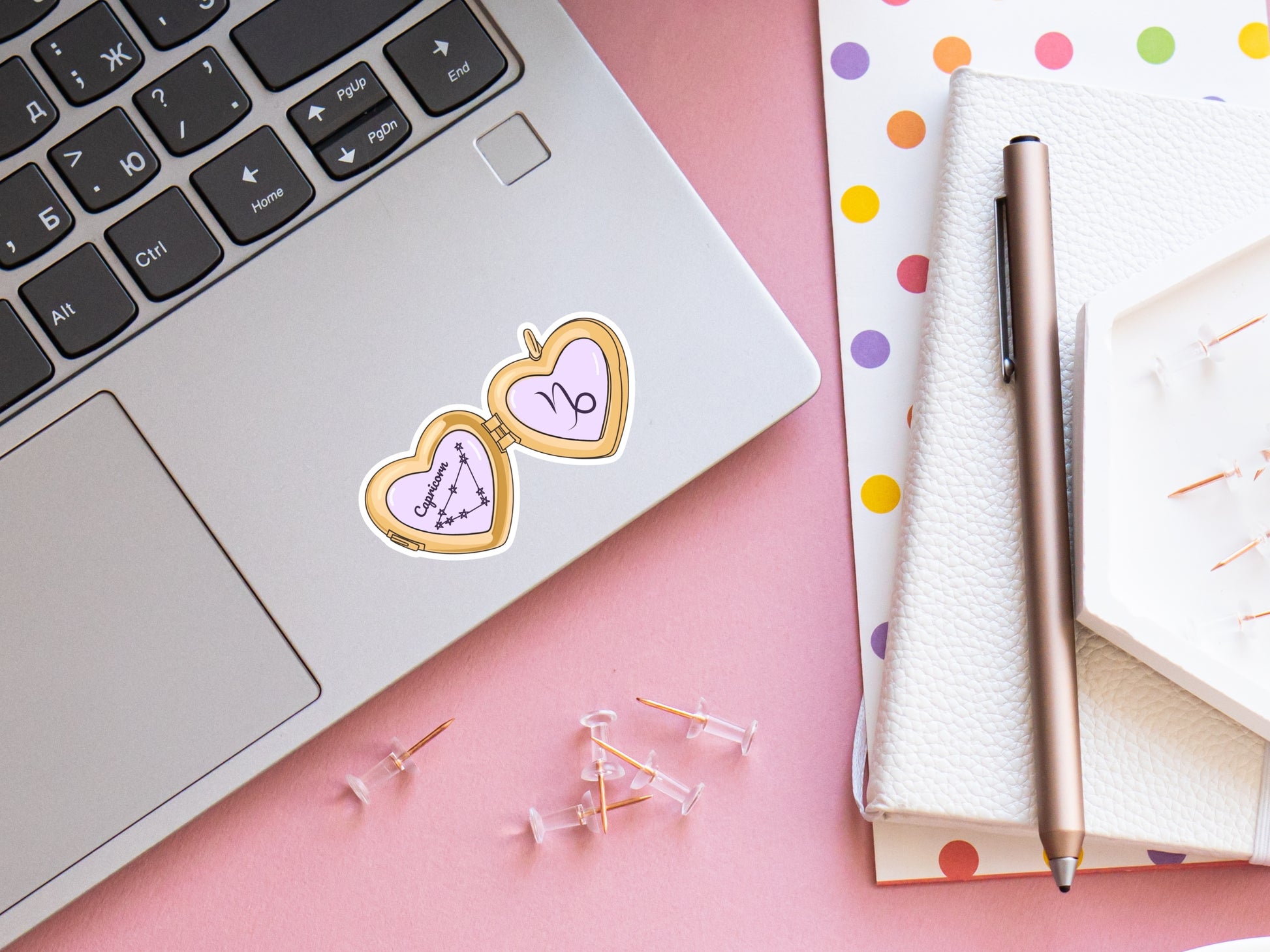 a cute trending and popular PNG digital download design of a gold love heart locket featuring a zodiac star sign and constellation symbol, finished with a purple lilac bow.  Can be used to create physical stickers or use for sublimation on clothing such as t shirts, jumpers and canvas bags