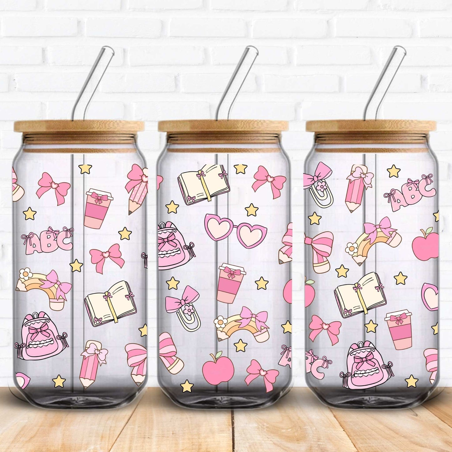Seamless kawaii-style pattern designed for a 16oz Libbey glass can, featuring pastel pink bows tied around pencils, pink notebooks, apples, paperclips, and yellow stars on a black background. The elements are illustrated with a soft, hand-drawn texture, creating a playful and school-themed aesthetic.