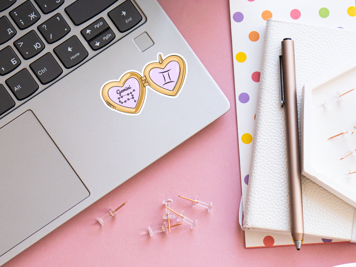 a cute trending and popular PNG digital download design of a gold love heart locket featuring a zodiac star sign and constellation symbol, finished with a purple lilac bow.  Can be used to create physical stickers or use for sublimation on clothing such as t shirts, jumpers and canvas bags