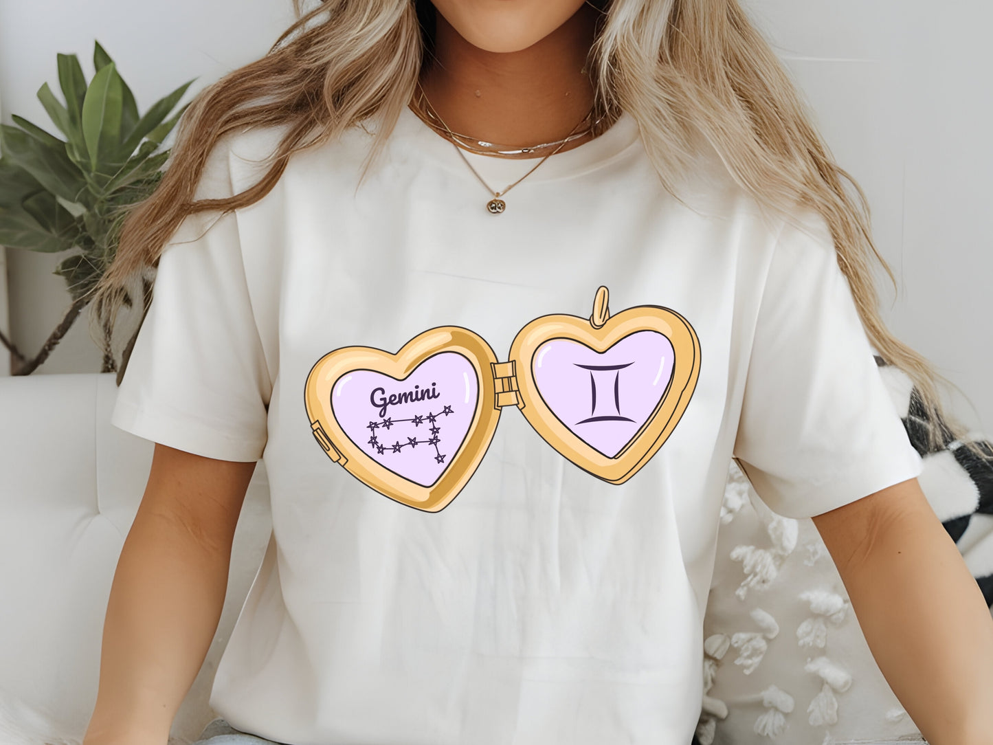 a cute trending and popular PNG digital download design of a gold love heart locket featuring a zodiac star sign and constellation symbol, finished with a purple lilac bow.  Can be used to create physical stickers or use for sublimation on clothing such as t shirts, jumpers and canvas bags
