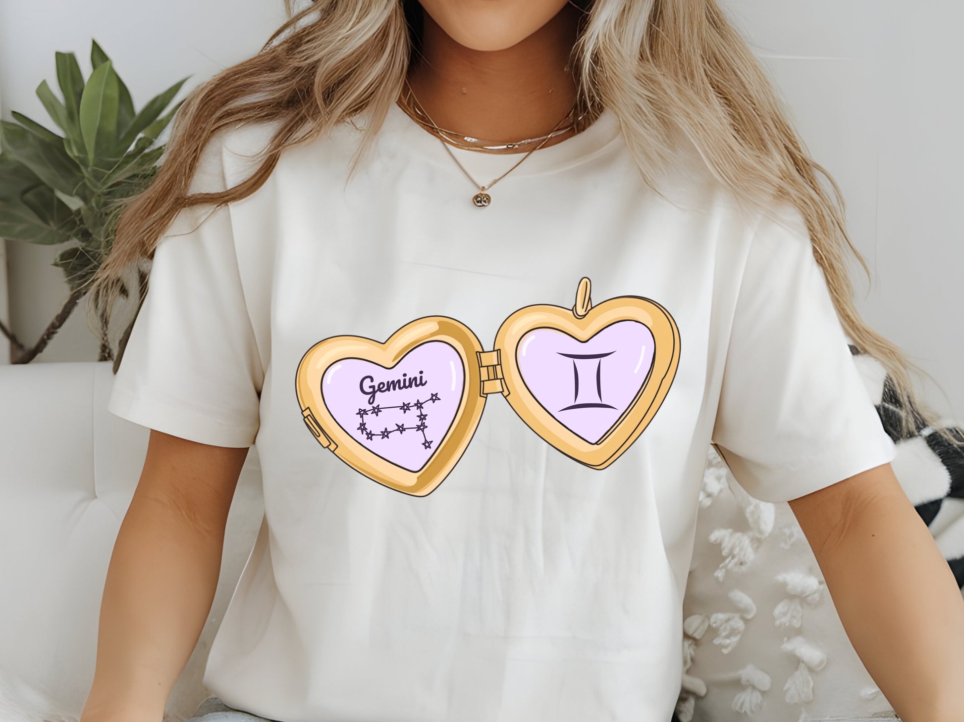 a cute trending and popular PNG digital download design of a gold love heart locket featuring a zodiac star sign and constellation symbol, finished with a purple lilac bow.  Can be used to create physical stickers or use for sublimation on clothing such as t shirts, jumpers and canvas bags