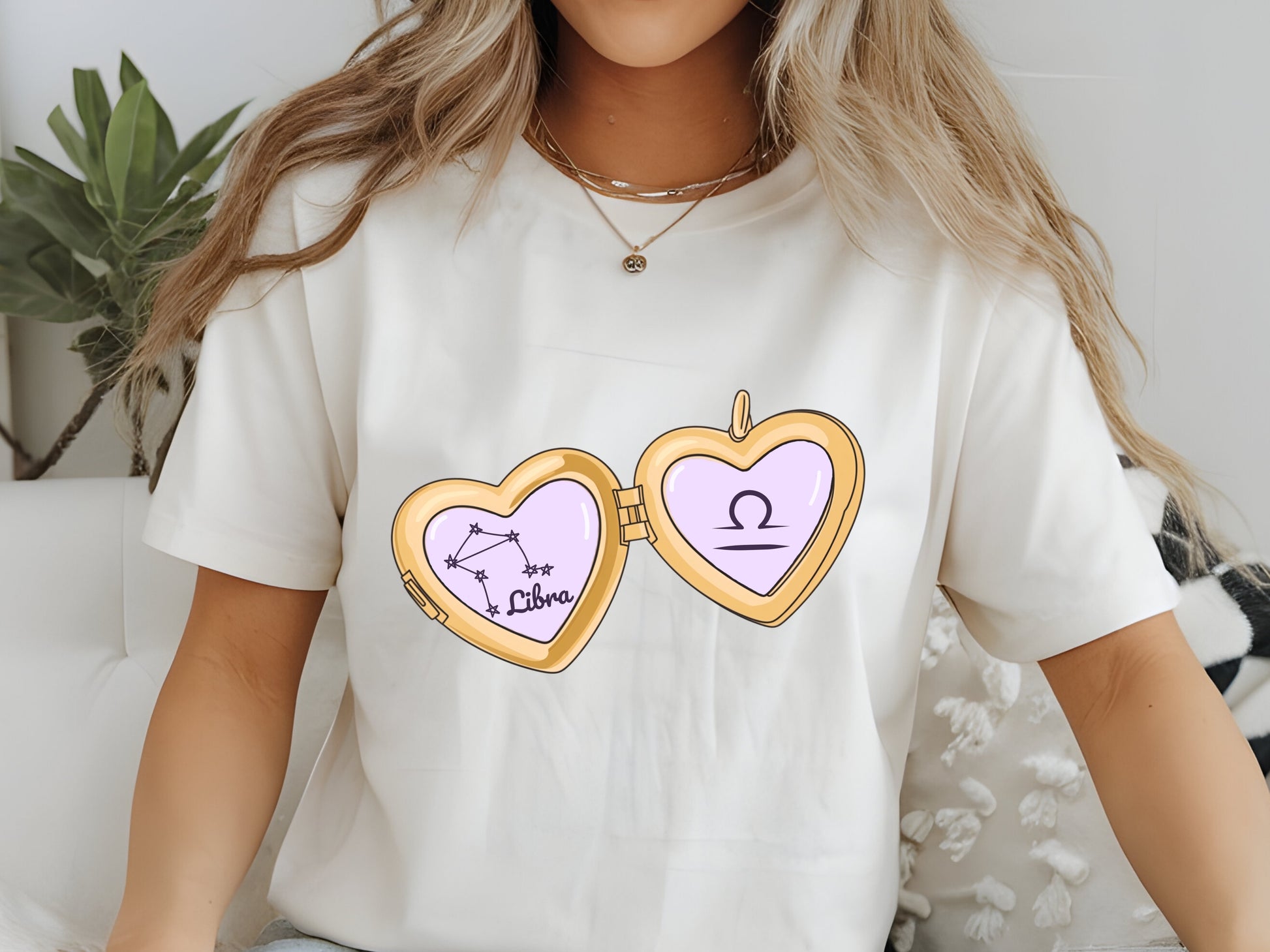 a cute trending and popular PNG digital download design of a gold love heart locket featuring a zodiac star sign and constellation symbol, finished with a purple lilac bow.  Can be used to create physical stickers or use for sublimation on clothing such as t shirts, jumpers and canvas bags