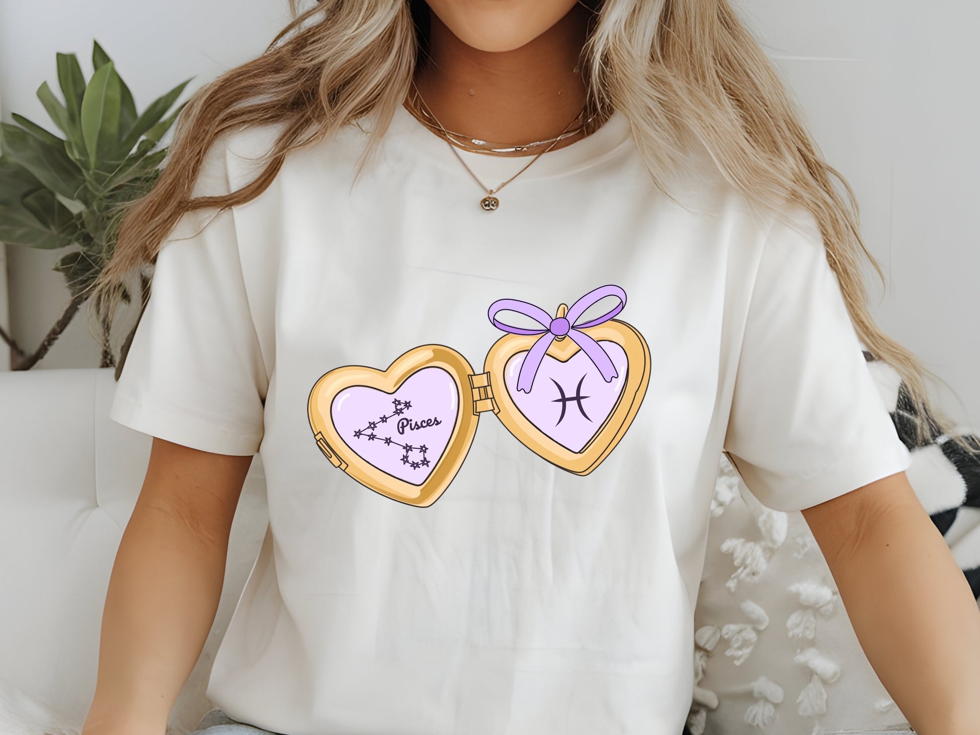 a cute trending and popular PNG digital download design of a gold love heart locket featuring a zodiac star sign and constellation symbol, finished with a purple lilac bow.  Can be used to create physical stickers or use for sublimation on clothing such as t shirts, jumpers and canvas bags