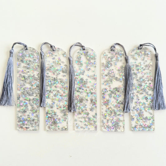 Clear acrylic bookmark blank filled with internal silver star glitter, measuring 12x3.2cm with a smooth finish, pre-cut hole, and tassel – perfect for UV DTF, vinyl, and custom designs.