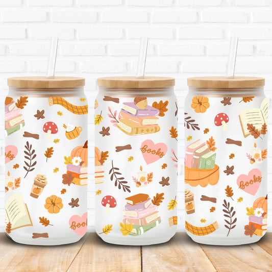 Autumn bookish sublimation wrap for 16oz and 20oz Libbey glass cans featuring cozy fall vibes with stacked books, pumpkins, candles, coffee cups, scarves, mushrooms, hearts with 'books' text, acorns, and autumn leaves. Seamless high-resolution PNG perfect for sublimation and UV DTF crafting. Ideal for book lovers, cozy reading season, fall décor, and pumpkin spice inspired glass can tumblers. Great gift for autumn readers and seasonal drinkware lovers.