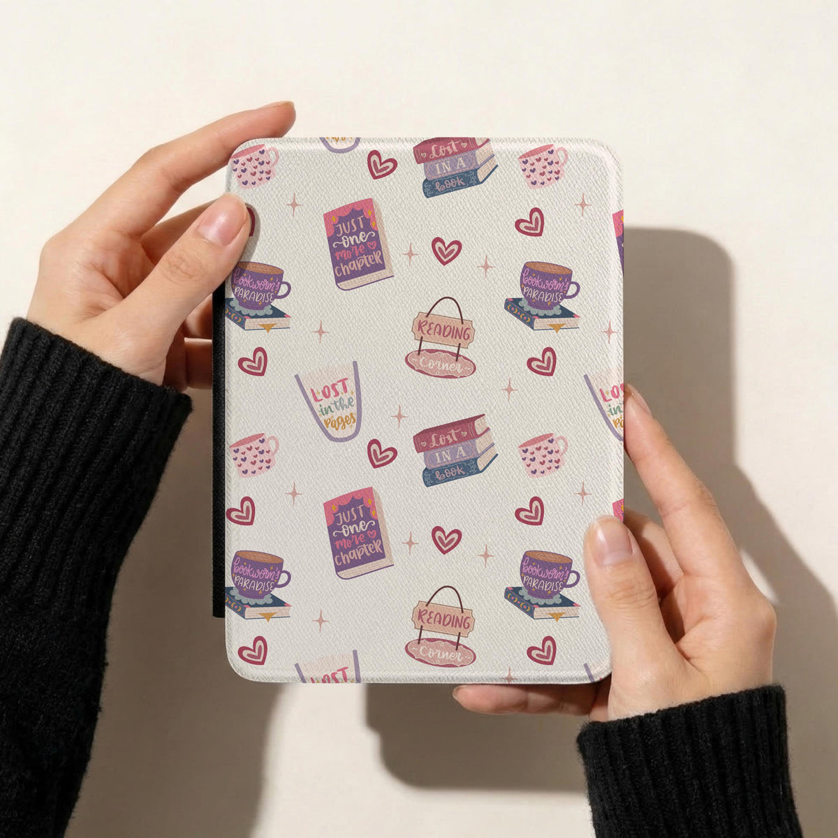 Book lover reading romance seamless pattern displayed on a Kindle cover featuring pastel book stacks, coffee mugs, reading signs and pink hearts.