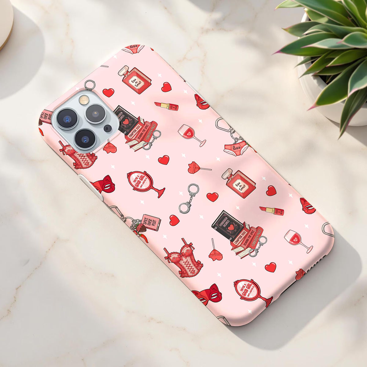 Pink spicy bookish romance seamless pattern on a phone case featuring red corsets, romance books, hearts, lipstick and masquerade masks.
