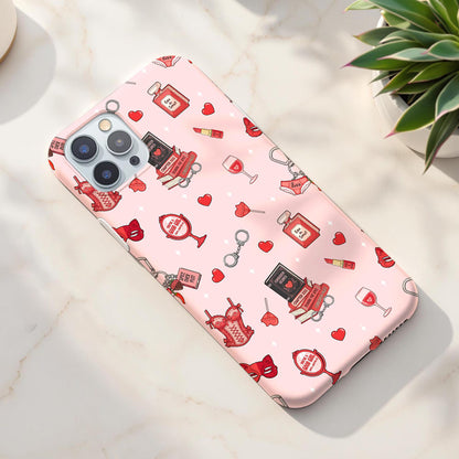 Pink spicy bookish romance seamless pattern on a phone case featuring red corsets, romance books, hearts, lipstick and masquerade masks.
