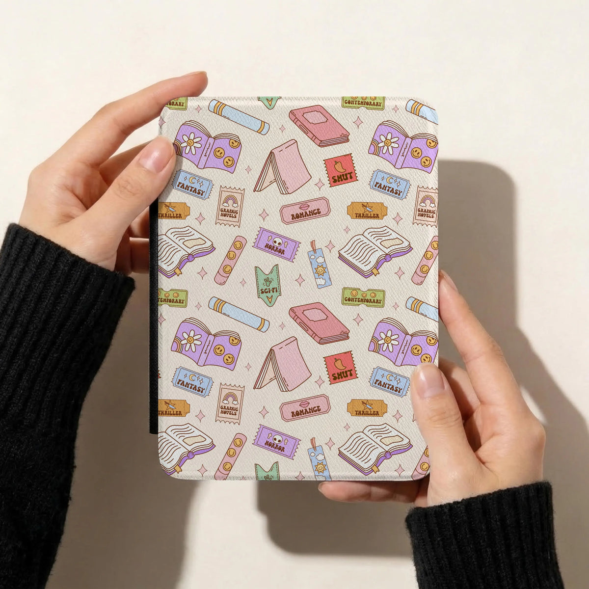 Pastel bookish reading genres seamless pattern on a Kindle cover featuring colourful books, bookmarks and romance, fantasy and thriller tickets.
