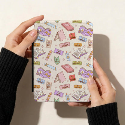 Pastel bookish reading genres seamless pattern on a Kindle cover featuring colourful books, bookmarks and romance, fantasy and thriller tickets.