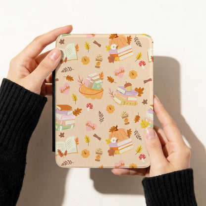 Cozy autumn bookish seamless pattern on a Kindle case featuring pumpkins, stacked books, coffee cups, mushrooms and fall leaves.