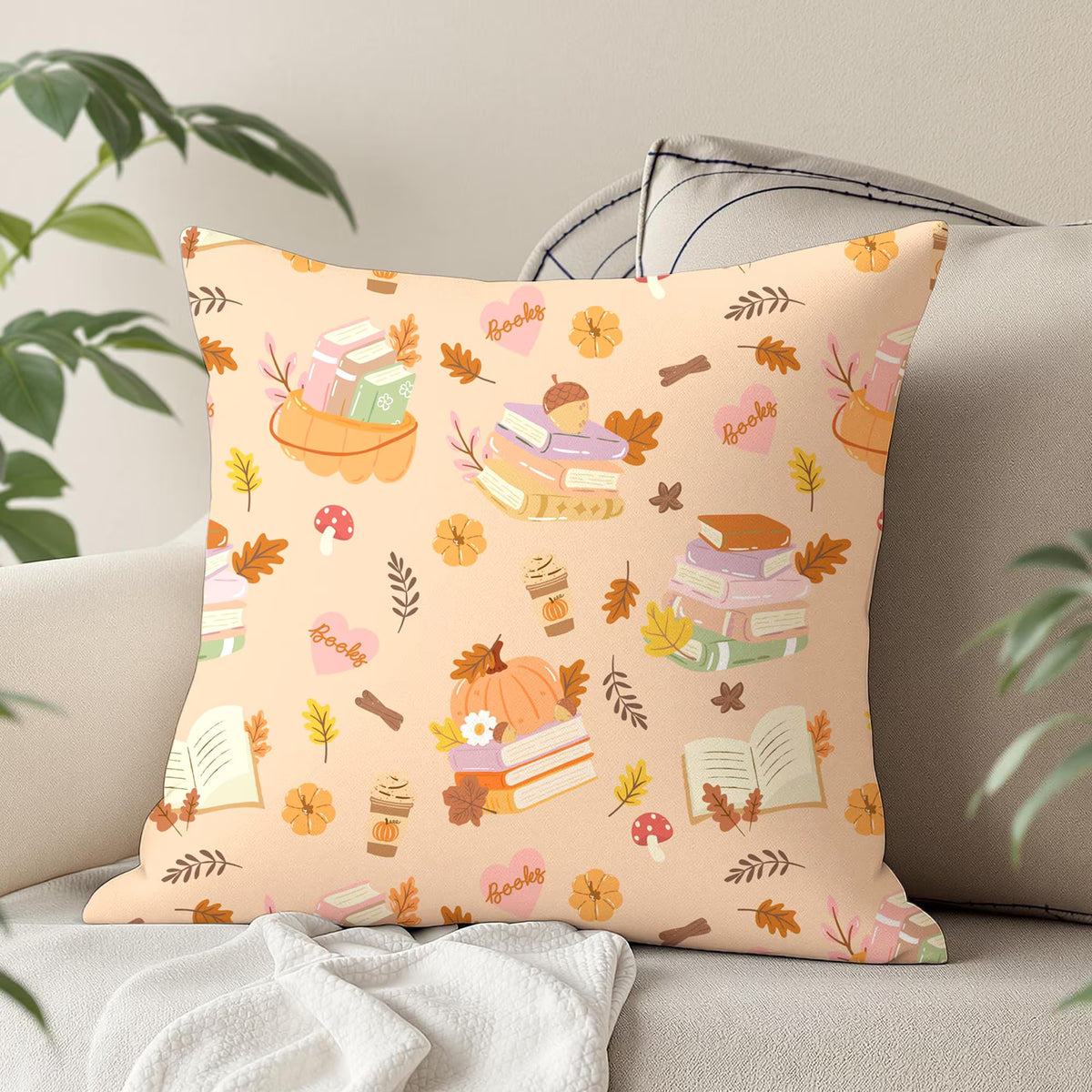 Autumn reading digital paper design printed on a decorative cushion with pastel books, pumpkins, acorns and orange autumn foliage.