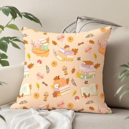 Autumn reading digital paper design printed on a decorative cushion with pastel books, pumpkins, acorns and orange autumn foliage.
