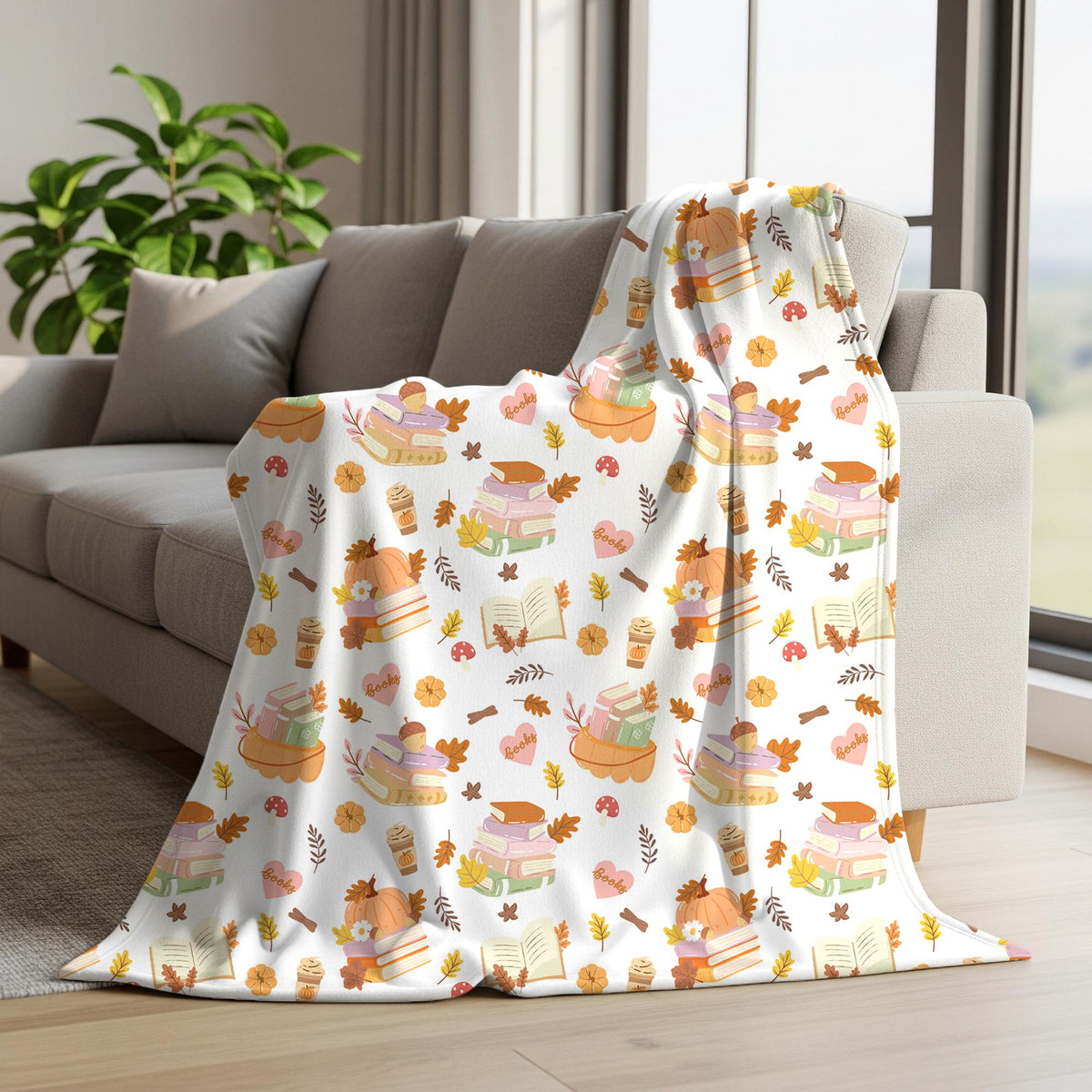 Cozy fall bookish seamless pattern displayed on a blanket draped over a sofa with pumpkins, open books, coffee and autumn leaves.