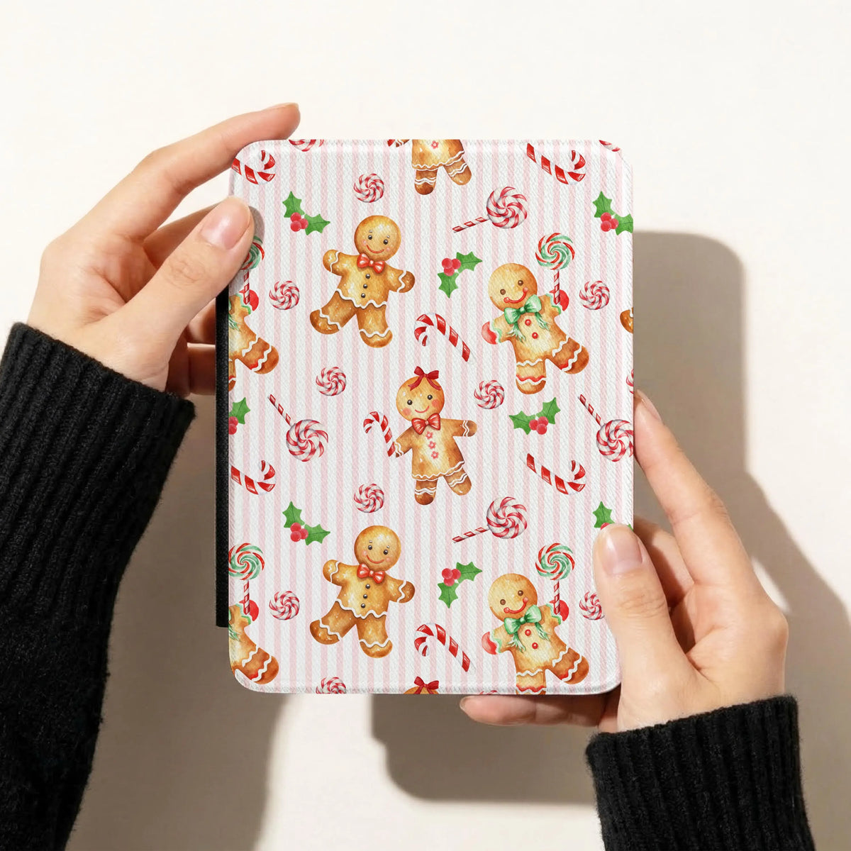 Pink gingerbread Christmas seamless pattern on a Kindle cover with watercolor gingerbread men, candy canes, peppermint lollipops and holly.