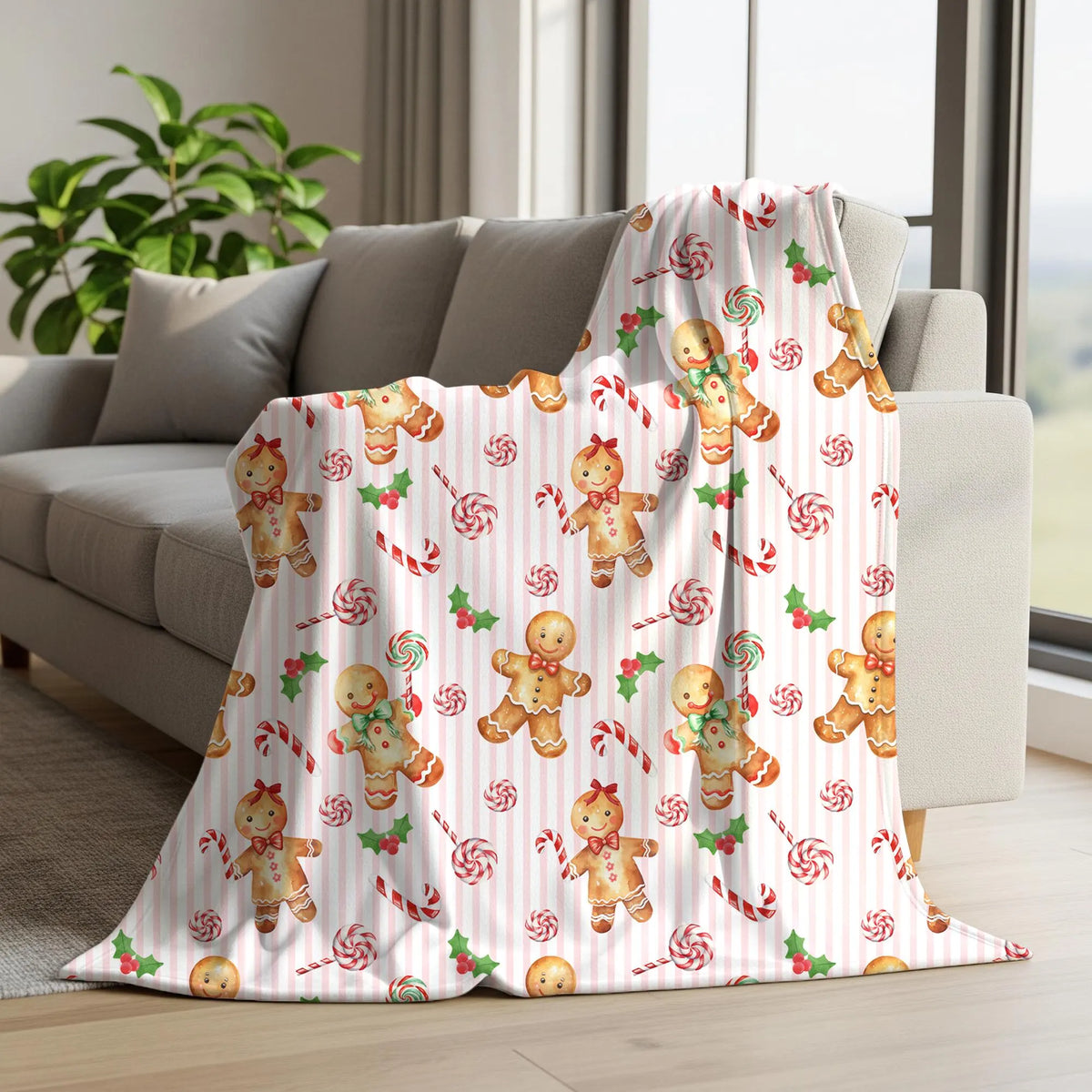 Gingerbread Christmas repeating pattern displayed on a fleece blanket with cute gingerbread cookies, red candy canes and pastel pink stripes.