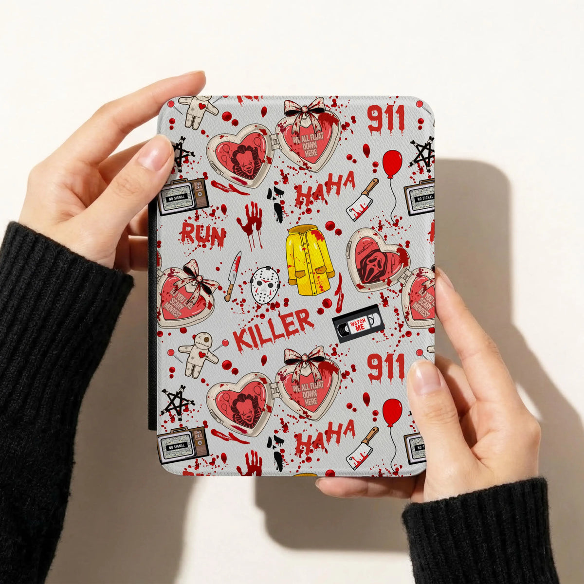 Horror movie slasher seamless pattern displayed on a Kindle cover featuring bloody knives, killer masks, red balloons and spooky VHS tapes.