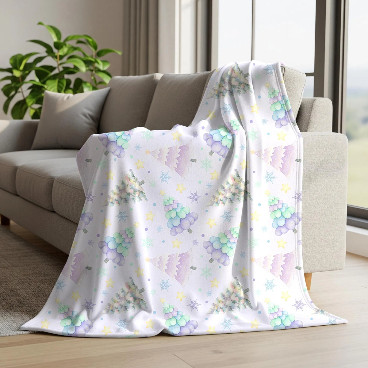 Soft pastel Christmas tree digital paper displayed on a fleece blanket with colourful watercolour trees, snowflakes and stars.