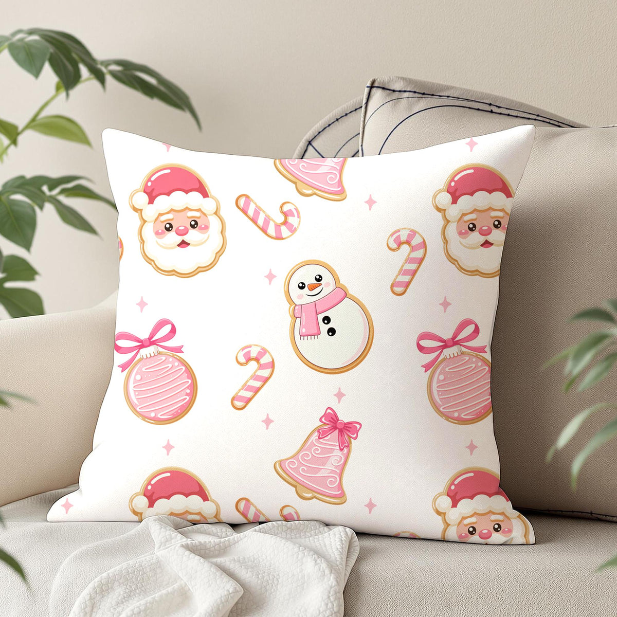 Cute pink Christmas seamless pattern on a decorative cushion featuring Santa cookies, snowman cookies, candy canes and pink Christmas ornaments.