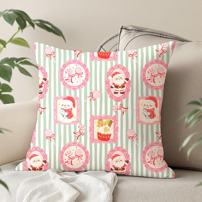 A square decorative throw pillow with a festive Christmas pattern, styled on a beige sofa with a white blanket and green plant leaves in the background.